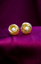 Load image into Gallery viewer, Gold spiral earrings with pearl centers on a purple background
